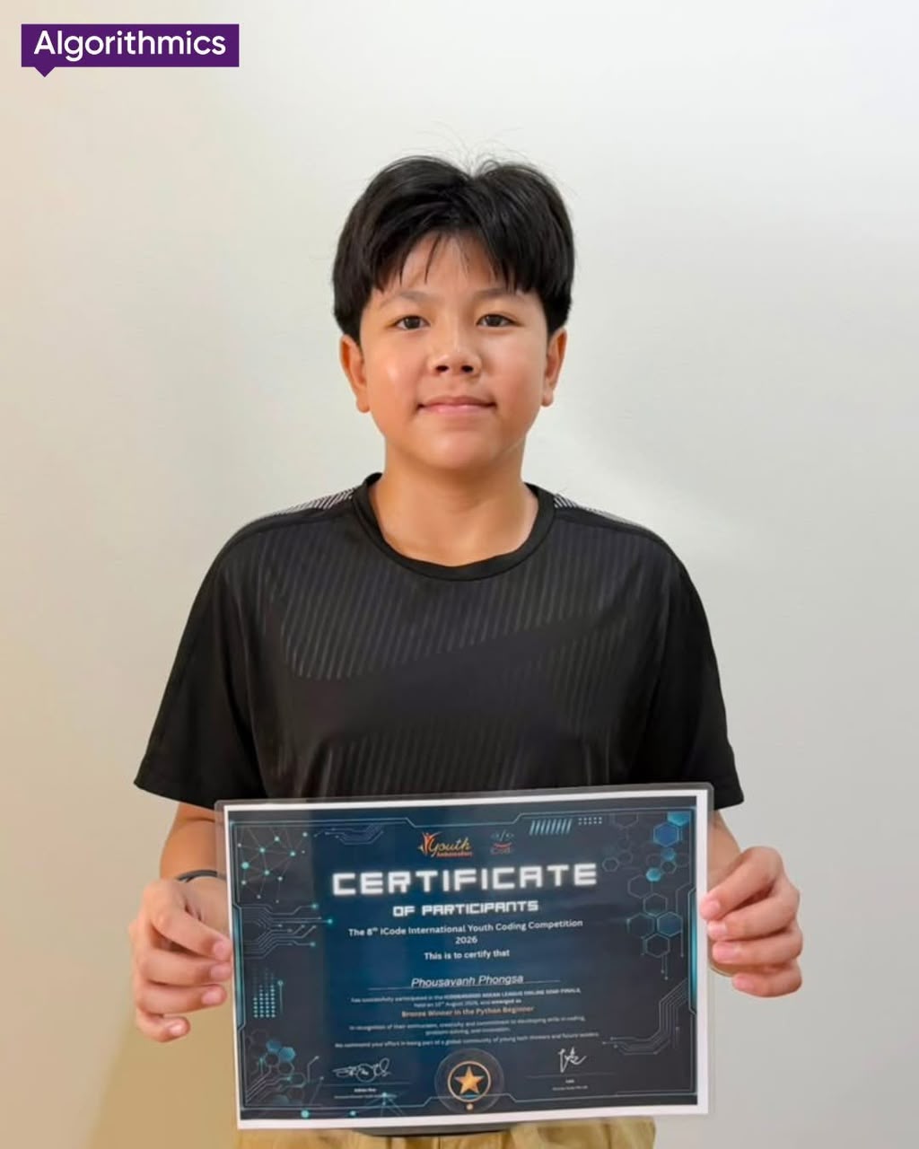 Algorithmics student holding a coding competition certificate
